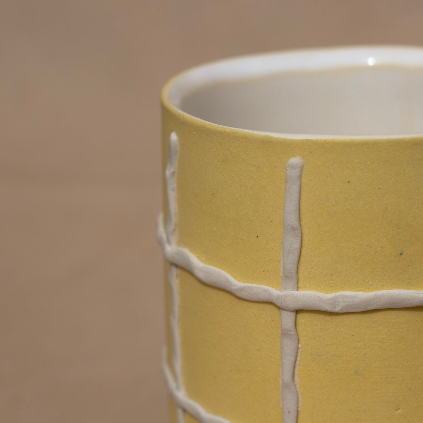 Close-up of a handmade yellow cup
