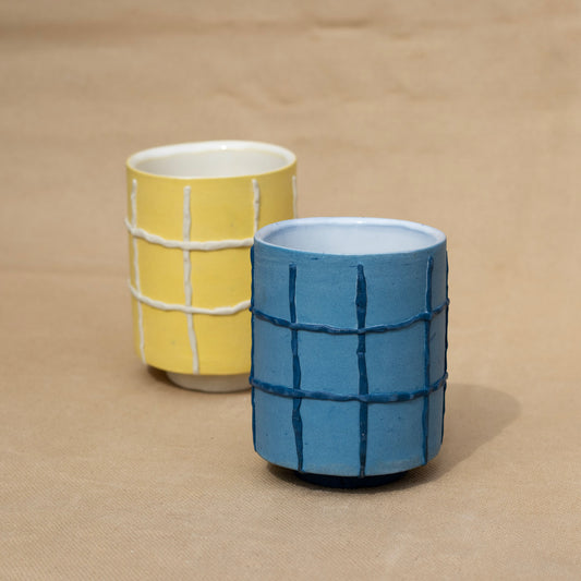 Handmade blue cup with a dark blue grid