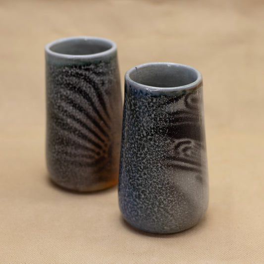 Two handmade tumblers with a hand drawn wavy pattern