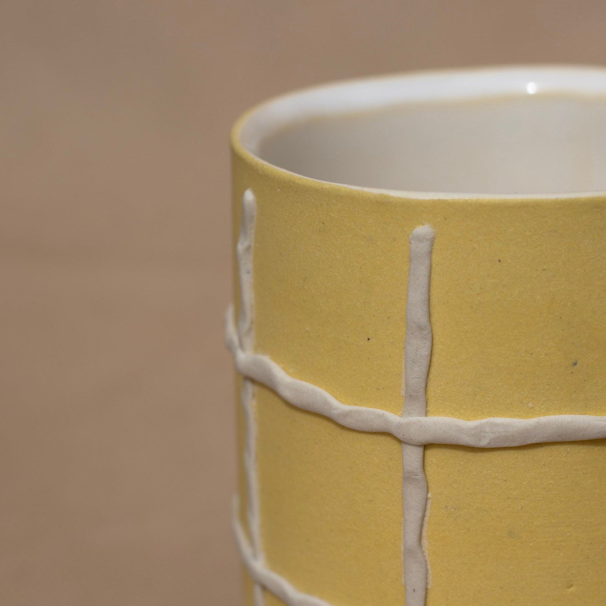 Close-up of a handmade yellow cup